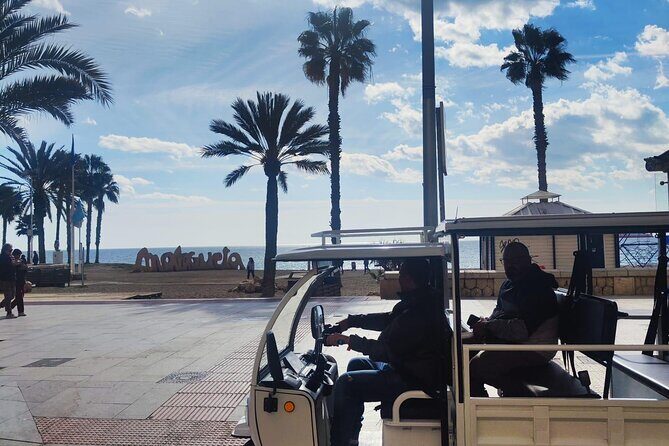 Malaga by Tuk Tuk i : 1 or 2 hours Private city tour - Malagueta Beach: urban coastline, dark sand, clear location