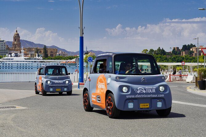 Málaga Sunset & Night Tour by Electric Car - Malagueta promenade and the Picasso name along the sea